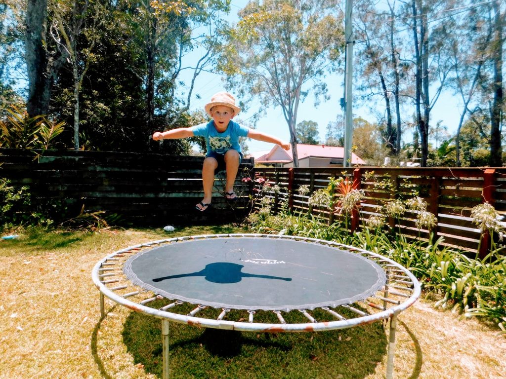 Child jumping on a trampoline.